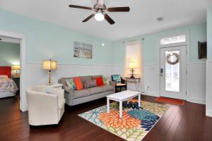 a living room with a couch and a ceiling fan at Barefoot Cottage D133 - Beachy Keen by Pristine Properties Vacation Rentals in Highland View
