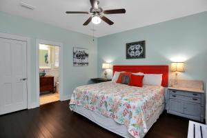a bedroom with a bed and a ceiling fan at Barefoot Cottage D133 - Beachy Keen by Pristine Properties Vacation Rentals in Highland View +35 photos