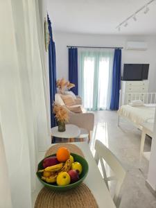 a bowl of fruit on a table in a living room at Sun & Moon Studio Afitos in Afitos