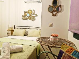 a bedroom with a bed and a table with a cake on it at Argento in Vrontádos