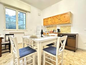 a kitchen with a table and chairs in a kitchen at A DUE PASSI da BARI - La Casa della Nonna al 39 in Noicattaro