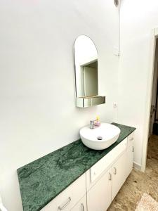 a bathroom with a sink and a mirror at A DUE PASSI da BARI - La Casa della Nonna al 39 in Noicattaro +23 photos