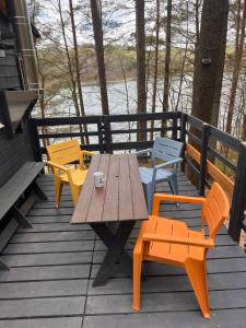 a wooden table and chairs on a deck at Kaszuby Mały Domek in Potuły +39 photos