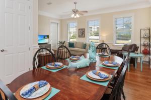 a dining room and living room with a table and chairs at Waterside Village Cottage 3220 by Pristine Properties Vacation Rentals in Mexico Beach