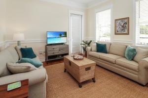 a living room with two couches and a tv at Waterside Village Cottage 3220 by Pristine Properties Vacation Rentals in Mexico Beach