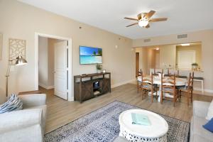 a living room with a table and a dining room at Waterside Village Condo 203 by Pristine Properties Vacation Rentals in Mexico Beach