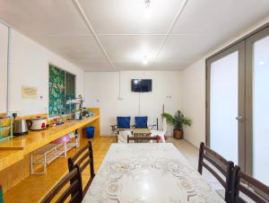 a dining room with a table and chairs at D' Limbai Cottage in Ranau