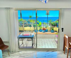 a room with a table and a view of the ocean at Beach and Sea View in Roquebrune-Cap-Martin