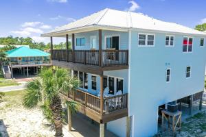 a house with a balcony and a gazebo at Beach Please by Pristine Properties Vacation Rentals in Indian Pass