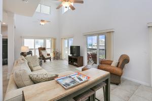 a living room with a couch and a table at Beach Please by Pristine Properties Vacation Rentals in Indian Pass