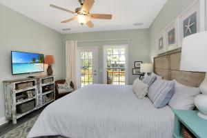 a bedroom with a bed and a ceiling fan at Bethany Cottage by Pristine Properties Vacation Rentals in Indian Pass +74 photos