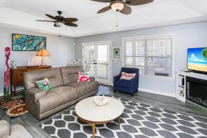 a living room with a couch and a table at Flamingo Roost by Pristine Properties Vacation Rentals in Indian Pass