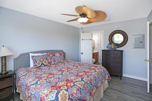 a bedroom with a bed and a ceiling fan at Flamingo Roost by Pristine Properties Vacation Rentals in Indian Pass