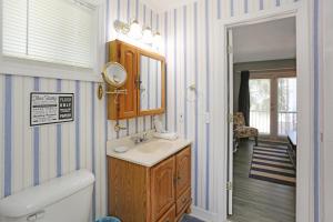 a bathroom with a sink and a mirror at Flamingo Roost by Pristine Properties Vacation Rentals in Indian Pass +53 photos
