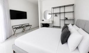a white bedroom with a white bed and a mirror at Sea 300 Villa in Migdal +25 photos