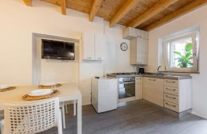 a kitchen with white cabinets and a table and a counter at Aura Milanese Milano in Milan +8 photos