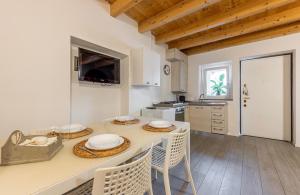 a kitchen with a table with chairs and a counter top at Aura Milanese Milano in Milan
