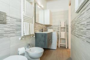 a bathroom with a sink and a toilet and a mirror at Aura Milanese Milano in Milan