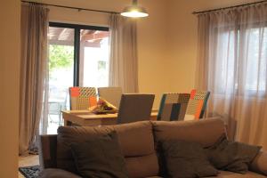 a living room with a couch and a table with chairs at Salt Lake Town House in Larnaca