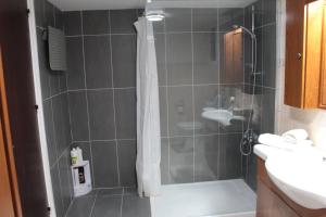 a bathroom with a shower and a sink at Salt Lake Town House in Larnaca +35 photos