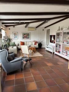 a living room with a couch and chairs and a table at Kaptenshuset B&B och Hotell in Kivik