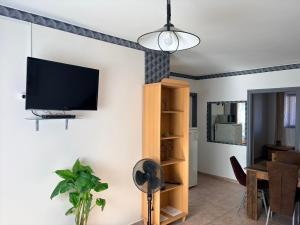 a living room with a flat screen tv on a wall at Jesolo Apartmanház in Balatonkeresztúr