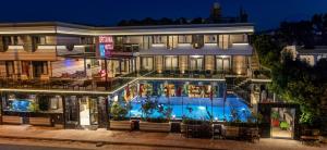 a building with a swimming pool in front of it at Britannia Hotel in Kemer +16 photos