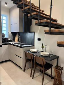a kitchen with a table with two chairs and a stove at ŌMNIMI Signature Living in Skala Potamias