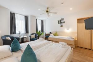 a hotel room with two beds and a tv at Hotel Gisela in Kufstein +77 photos