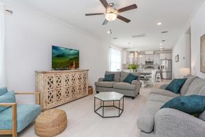 a living room with a couch and a table at Keys to the Cape by Pristine Properties Vacation Rentals in Cape San Blas
