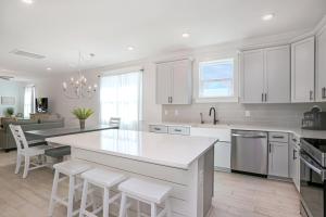 a kitchen with white cabinets and a white counter top at Keys to the Cape by Pristine Properties Vacation Rentals in Cape San Blas