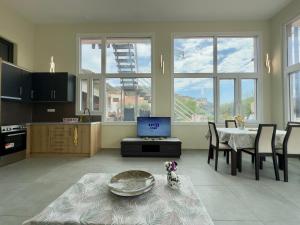 a living room with a table and a dog sitting on a rug at Rodia 1 in Pteleos