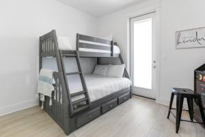 a bedroom with a bunk bed with a ladder at Keys to the Cape by Pristine Properties Vacation Rentals in Cape San Blas +52 photos