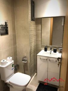 a bathroom with a white toilet and a sink at JB Apartment -B18- in Kenitra +9 photos