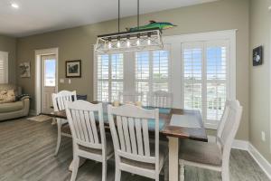 a dining room with a table and white chairs at Lala's Place by Pristine Properties Vacation Rentals in Mexico Beach