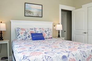 a bedroom with a bed with a blue pillow on it at Lala's Place by Pristine Properties Vacation Rentals in Mexico Beach