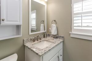a bathroom with a sink and a mirror at Lala's Place by Pristine Properties Vacation Rentals in Mexico Beach +30 photos