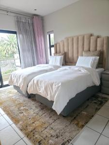 a bedroom with a large bed and a large window at AB&AB Guesthouse Bedfordview in Germiston +40 photos
