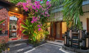 a building with flowers on the side of it at Pondok Taksu Bali in Kuta +14 photos