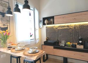 a kitchen with a table with chairs and a counter top at Ciatu Miu Spa Suite Gambino in Carini +41 photos