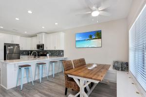 a kitchen with a wooden table and chairs at Beach Fantasies B by Pristine Properties Vacation Rentals in Mexico Beach
