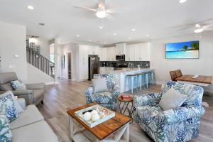 a living room with blue and white furniture and a kitchen at Beach Fantasies B by Pristine Properties Vacation Rentals in Mexico Beach