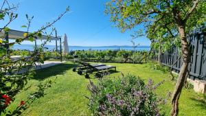 a park with a picnic table in the grass at Mediterranean House - Forest Marjan in Split