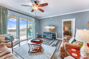 a living room with a couch and a tv at Summerhouse 101 - Pearl of the Gulf by Pristine Properties Vacation Rentals in Mexico Beach