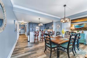 a dining room and kitchen with a table and chairs at Summerhouse 101 - Pearl of the Gulf by Pristine Properties Vacation Rentals in Mexico Beach