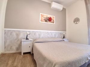 a bedroom with a bed and a picture on the wall at Dolce Dormire Civitanova Marche in Civitanova Marche