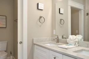 a white bathroom with a sink and a toilet at The Great White 2 by Pristine Properties Vacation Rentals in Beacon Hill +43 photos