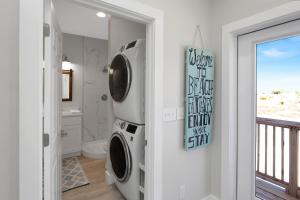 a bathroom with a washer and dryer at Beach Fantasies A by Pristine Properties Vacation Rentals in Mexico Beach