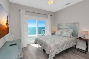 a bedroom with a bed with a view of the ocean at Beach Fantasies A by Pristine Properties Vacation Rentals in Mexico Beach