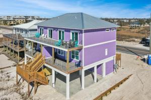 an overhead view of a purple house on the beach at Beach Fantasies A by Pristine Properties Vacation Rentals in Mexico Beach